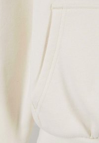 Cream-colored hoodie featuring a front pocket, ribbed cuffs and hem, and a soft, textured fabric. Seams are neatly stitched for durability.