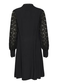 Black dress featuring long lace sleeves, a buttoned cuff, and a textured back with a pleated design for added detail.