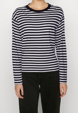 Navy and white striped long-sleeve shirt with a rounded neckline and fitted silhouette, made of soft fabric. Worn with black pants.