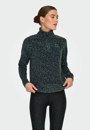 Donkergrijze fleece quarter-zip top met een zwart luipaardpatroon. Heeft een staande kraag en elastische manchetten. Gecombineerd met zwarte leggings.