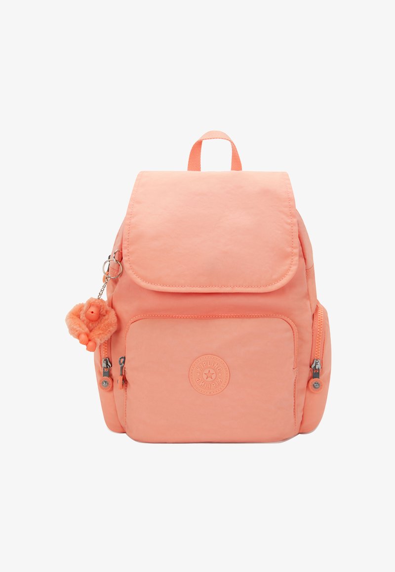 Sac à dos couleur pêche avec fermeture à rabat, poche avant zippée et porte-clés singe texturé. Comprend un logo et des compartiments latéraux zippés.