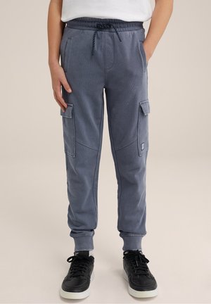 Pantaloni della tuta grigio carbone con vita elastica e coulisse, dotati di tasche cargo laterali e polsini a costine. Realizzati in tessuto morbido e strutturato.