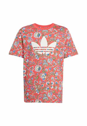 Floral-patterned red cotton t-shirt featuring an oversized white Adidas logo in the center, short sleeves, and a round neckline.