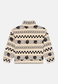 Maglione crema con motivi geometrici e floreali neri, colletto alto e polsini a coste. Realizzato in un tessuto morbido con una texture accogliente.