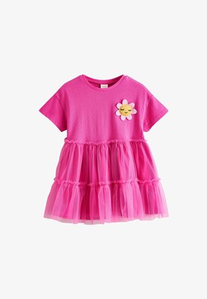 Abito rosa con parte superiore in cotone e gonna a strati in tulle, con rouches elastiche e un'applicazione floreale sul petto.