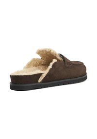 Brown suede open-back slipper with a fluffy beige lining and black rubber sole, featuring a stitched detail on the upper.