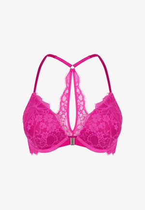 Roze kanten beha met een diepe V-rug, voorzien van bloemmotieven, verstelbare bandjes en een centrale metalen sluiting. Fijne franjes langs de randen.