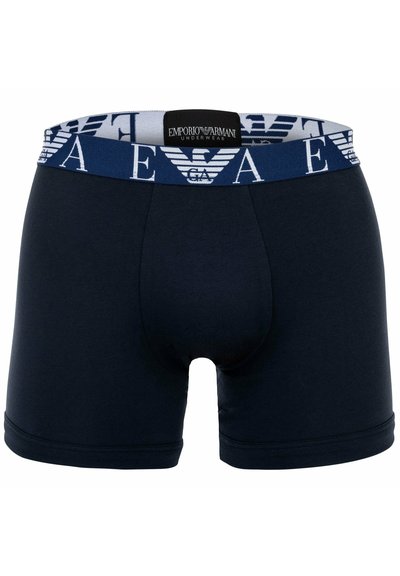 Marineblaue Boxer-Shorts aus Baumwolle, mit einem weißen, markierten elastischen Bund mit geometrischen Mustern und einer figurnahen Passform.