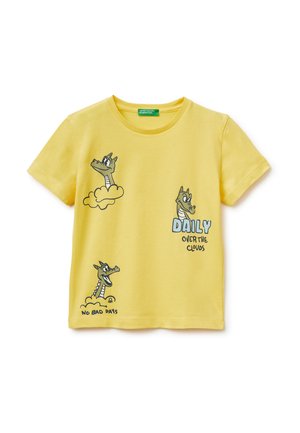 Gelbes kurzärmliges T-Shirt mit Zeichentrick-Drachengesichtern, Wolken und dem Text "DAILY OVER THE CLOUDS" sowie "NO BAD DAYS" auf der Vorderseite.