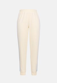 Pantalon de survêtement fuselé de couleur crème avec taille et poignets élastiques, conçu pour un usage décontracté.