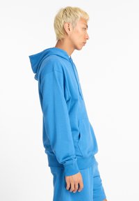 New Balance SPORT ESSENTIALS FRENCH TERRY - Hoodie - blue light blue