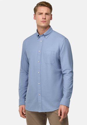 Camisa de manga larga azul claro con cuello abotonado, un bolsillo en el pecho y cierre frontal con botones; fabricada en tejido suave.