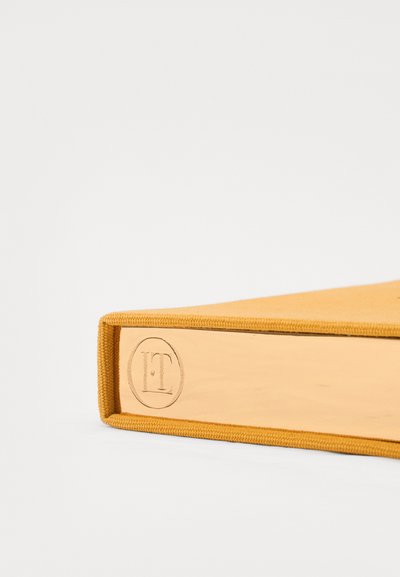 Yellow suede-covered book with a metallic gold edge, featuring an embossed logo. Smooth texture and clean lines design.