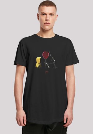 Black cotton t-shirt featuring a graphic of a yellow hooded figure and a clown with a red balloon, detailed with the text "IT."