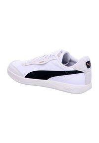 White Puma sneaker with black stripe, lace-up design, and cushioned sole angled to show outer side and heel logo.