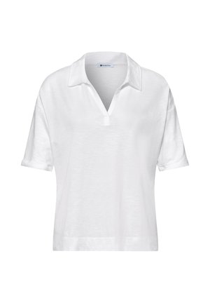 Polo bianca a maniche corte con colletto e scollo aperto, dal taglio ampio e polsini leggermente risvoltati.