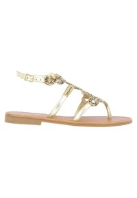 Gold metallic sandals with beaded accents, adjustable strap, flat sole, open design, featuring three front straps and cushioned insole.