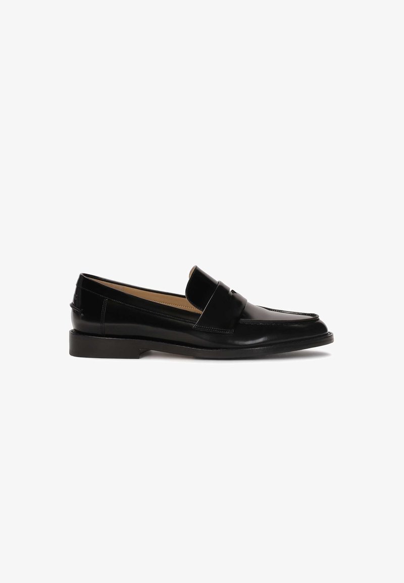 Black leather loafers with a smooth finish, rounded toe, and a decorative strap across the front. Low block heel design.
