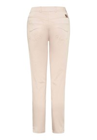 Pale beige trousers made of soft fabric, featuring a straight leg design, two back pockets, and stitched details along the seams.