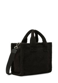 Borsa tote in tessuto nero e strutturato, con manici corti e una tracolla staccabile. Presenta una forma definita e cuciture visibili come dettaglio decorativo.