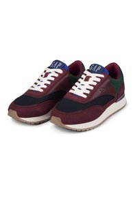 Maroon and black sneakers with white laces, padded collar, and green and blue accents. Features a textured upper and rubber sole.