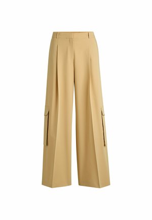 Beige weiße Hosen aus glattem Stoff, mit vorderen Falten und zwei seitlichen Cargo-Taschen mit Klappen. Maßgeschneiderte Taille für eine optimale Passform.