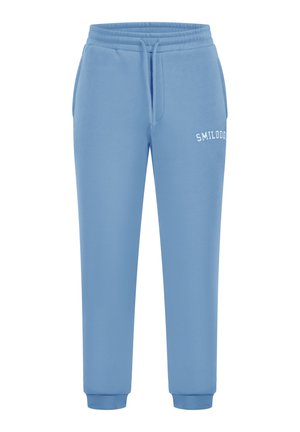 Pantalones deportivos azules de tela suave, con una cinturilla elástica, tobillos ajustados y texto blanco "SMILODON" en el muslo izquierdo.