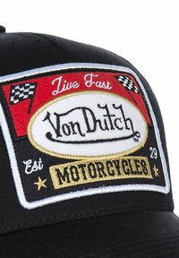 Black cap featuring a multi-colored embroidered patch with checkered flags and text "Live Fast Von Dutch Motorcycles" and a gold accent.