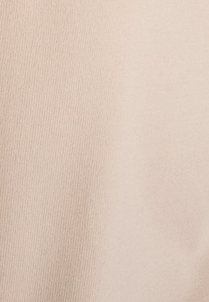 Tejido beige acanalado que presenta una textura suave y un tejido fino y uniforme. Sin patrones ni acentos visibles. Proporciona una apariencia lisa y uniforme.