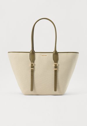 Beige canvas tote bag with olive green faux leather handles and accents, featuring a structured shape and gold-toned hardware.