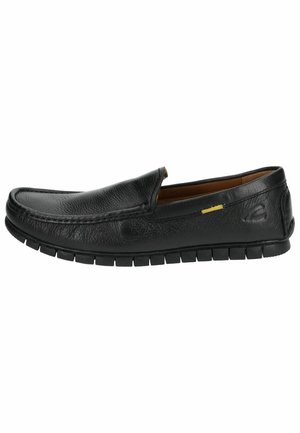 Mocassin noir en cuir à enfiler avec surface texturée, semelle souple rainurée et un petit détail en tissu jaune sur le côté.