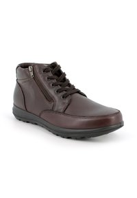 Stivali ankle in pelle marrone con lacci e zip laterale. Presentano una finitura liscia, punta arrotondata e suola in gomma testurizzata per una migliore aderenza.