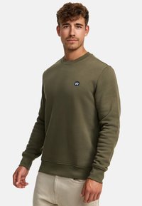 Olivgrüner Sweatshirt aus Baumwollmischung mit Rundhalsausschnitt, gerippten Bündchen und kleinem besticktem Logo auf der Brust.
