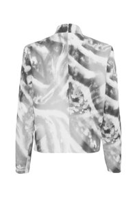 Top a maniche lunghe cropped con un motivo astratto tie-dye in bianco e nero, caratterizzato da un colletto alto e una chiusura con zip sul retro. Tessuto morbido e leggero.
