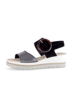 Black and gray sandal with a leather strap, wide front band, and an adjustable back strap. Features a round accent and wedge sole.