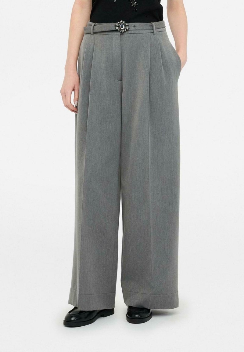 Gray wide-leg trousers with pleats, featuring a decorative belt with a floral accent. Made from a smooth fabric, structured fit.
