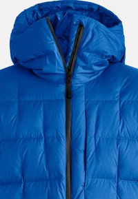 Blue padded jacket with a hood, featuring a zip closure and a quilted design. The material has a slight sheen and grid pattern.