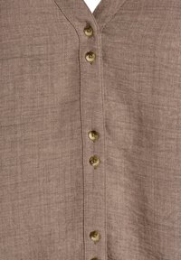 Brown linen shirt with a V-neckline, featuring vertical stitching and five buttons in a contrasting light tone.