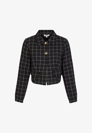 Giacca corta a quadri bianca e nera con collo a revers, tasche frontali e bottoni color oro. Tessuto strutturato con frange all'orlo.