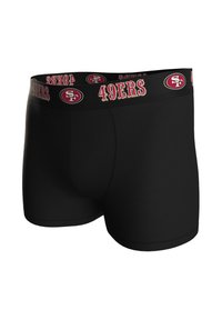 Musta bokseritrikoot, joissa leveä, kuminauhasta valmistettu vyötärönauha, jossa on "49ers" ja logo punaisena ja kultaisena. Sileä kangas, istuva muotoilu, eikä näkyviä kuvioita.