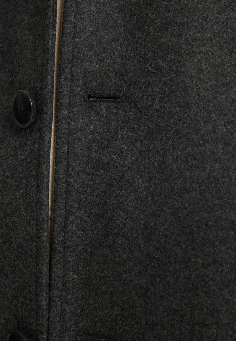 Grijze wollen jas met een gestructureerde afwerking, twee grote zwarte knopen en een klein zijvak met een nette naaddetail.