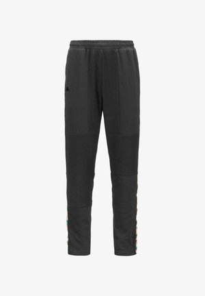 Pantaloni di felpa neri in pile con una finitura testurizzata, caratterizzati da pannelli laterali e accenti colorati a motivo lungo le gambe. Vita elasticizzata.