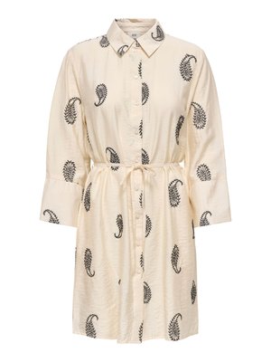 Krém színű ingruha fekete paisley mintákkal, gombos elöl, hosszú ujjú, hegyes gallérral és derékban megkötős övvel.