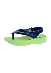 Blue rubber flip-flop sandal with a textured surface, green sole, and an adjustable fabric strap; features "Ipanema" logo and Brazilian flag.