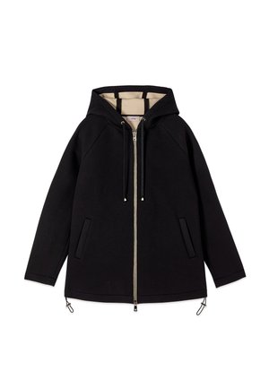 Musta hupullinen vetoketjullinen takki beigenvärisellä vuorella, pitkät hihat, kaksi etutaskua ja säädettävät kiristysnauhat helmassaan.