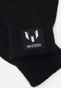 Gants en laine noirs ornés d'une étiquette rectangulaire noire avec un logo "M" stylisé en blanc et le texte "MESSi" au niveau du poignet.