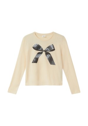 Jasno-beżowa koszula z długim rękawem, wykonana z miękkiej bawełny, z dużą czarną grafiką w kropki umieszczoną na środku. Prosty okrągły dekolt.