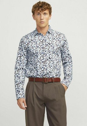 White long-sleeve shirt with blue and brown floral pattern, fitted design, and a button-down collar, paired with brown pleated trousers and belt.