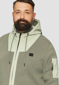 s.Oliver MIT ÄRMELTASCHE - Cardigan - olivgrün