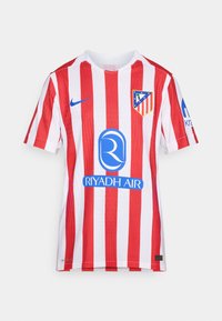 Punainen ja valkoinen raidallinen jalkapallopaita, joka on valmistettu hengittävästä kankaasta. Edessä on Nike-logo, joukkueen vaakuna ja sininen sponsorilogo.